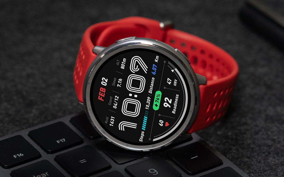 Amazfit Active 2 smartwatch with red Sport strap resting on a laptop keyboard